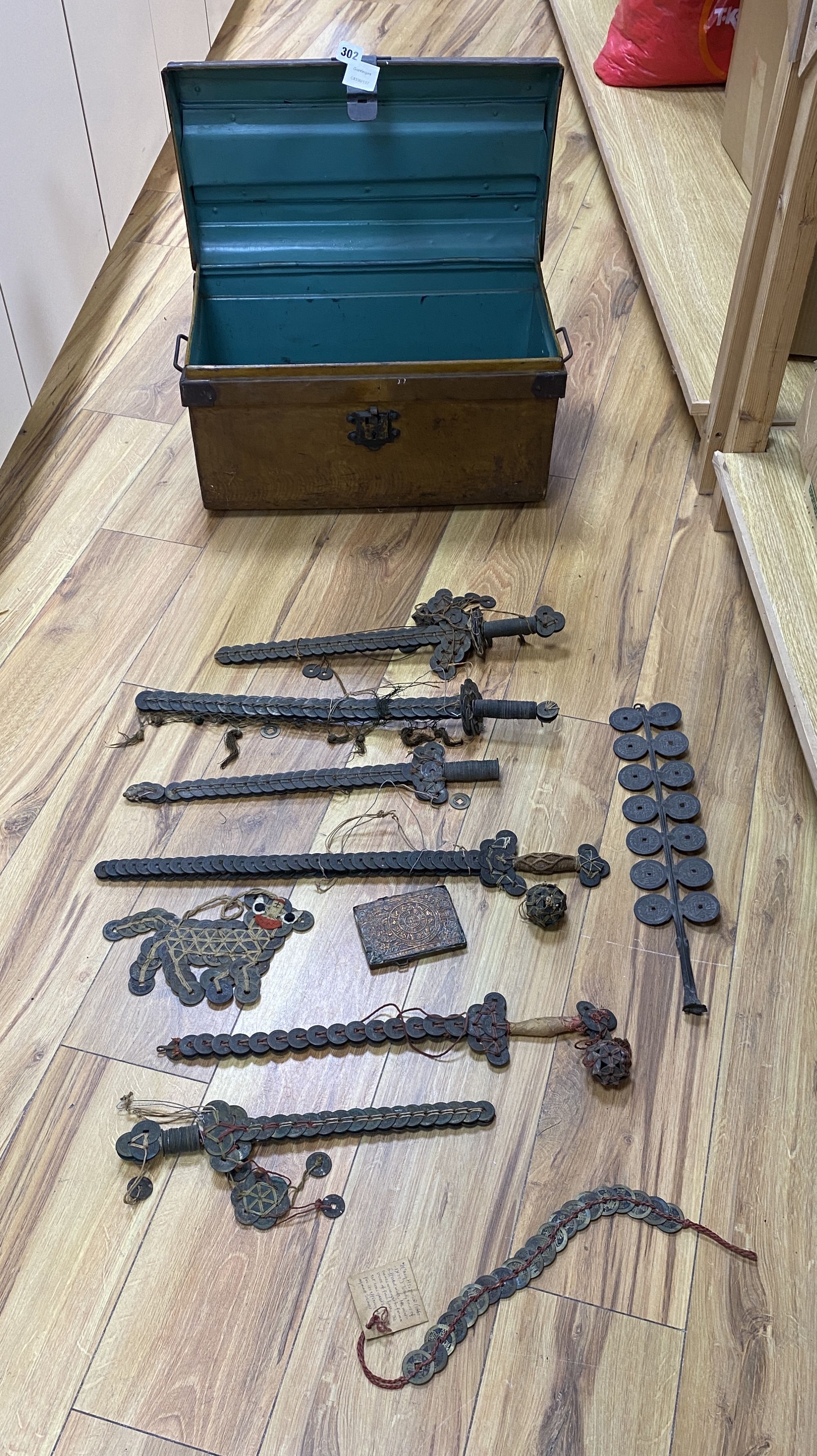 A group of Chinese coin swords and talismans,